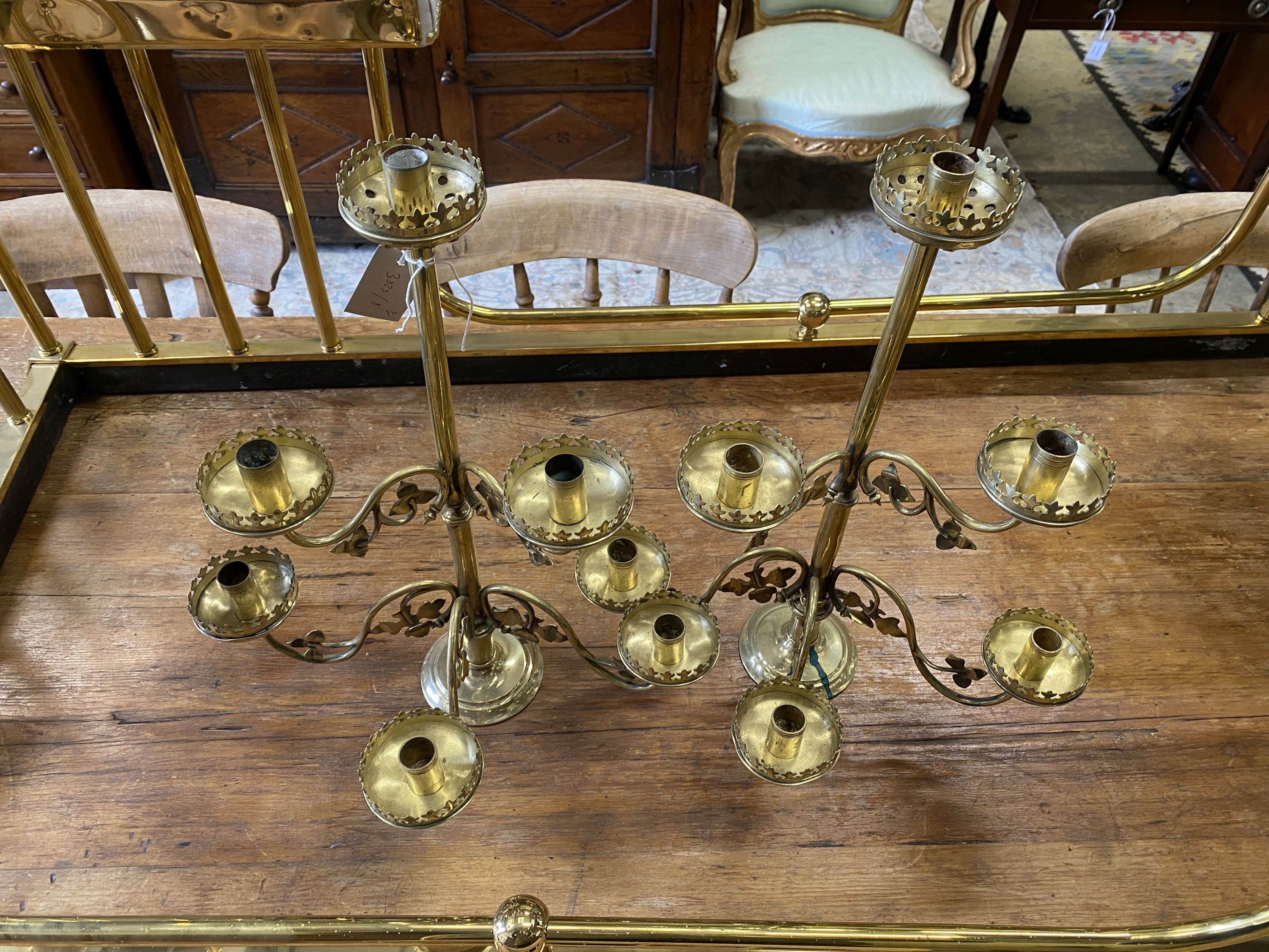 A pair of Victorian brass six branch candlesticks, height 52cm